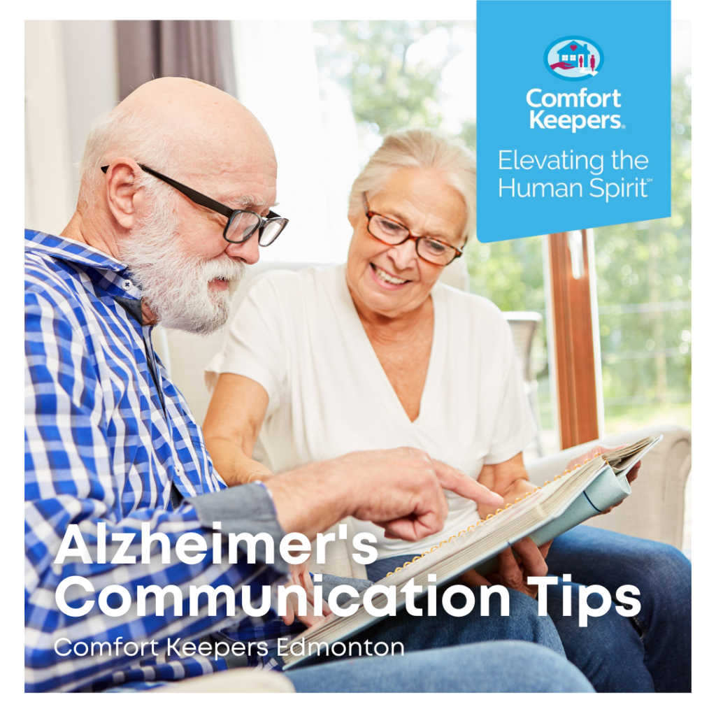 Alzheimer's Communication Tips | Two seniors seated on couch looking through book | Comfort Keepers Edmonton | BLOG POST