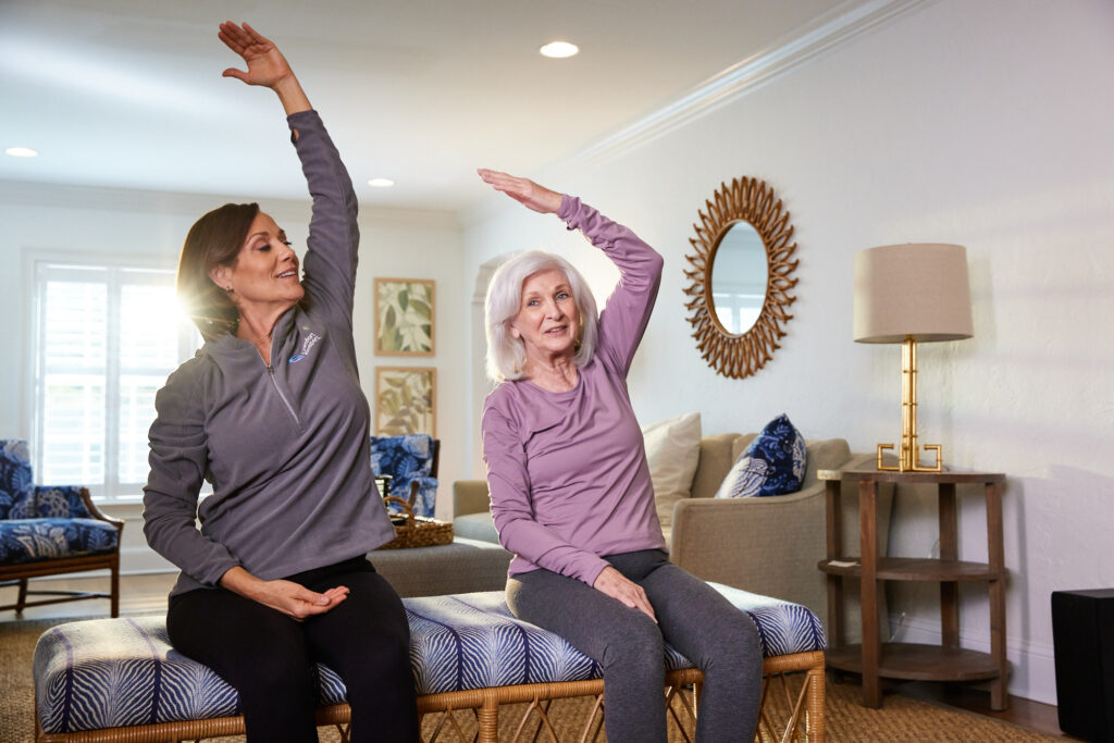 Light exercise: a Comfort Keepers PSW helping an elderly client with stretching and light exercise from the comfort of home.