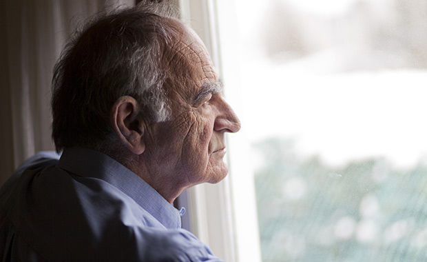 Senior Man looking out the window | Social Wellness Benefits Seniors | Comfort Keepers North and West Vancouver | BLOG POST