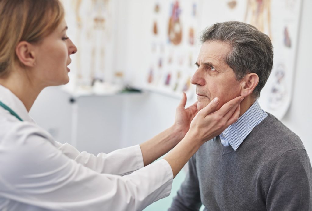 Senior receiving doctor's exam | Thyroid Disease in Seniors | Comfort Keepers Vancouver | BLOG POST