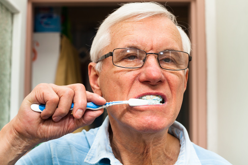 Senior male brushing his teeth | Senior Dental Hygiene | BLOG POST | Comfort Keepers Vancouver