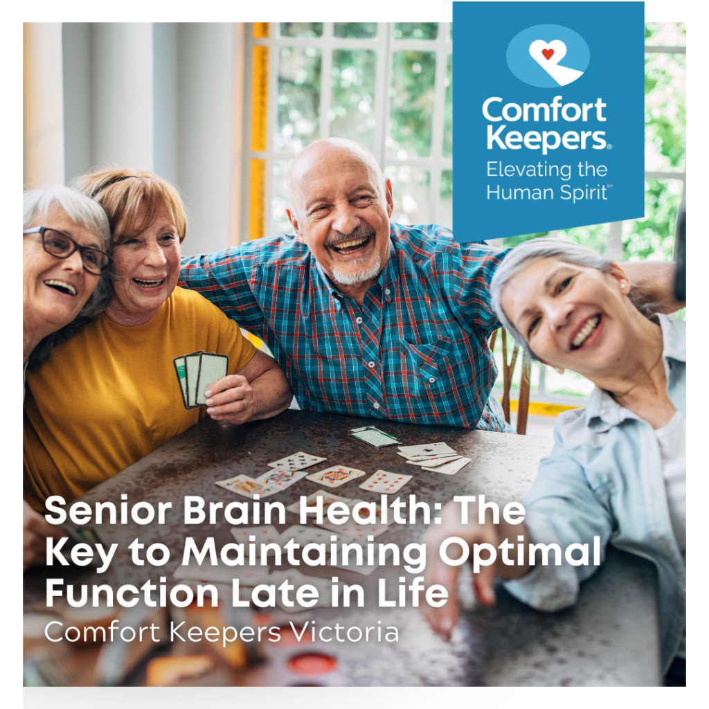 Senior seated at table at smiling | Senior Brain Health - The Key to Maintaining Optimal Function Late in Life - Comfort Keepers Victoria