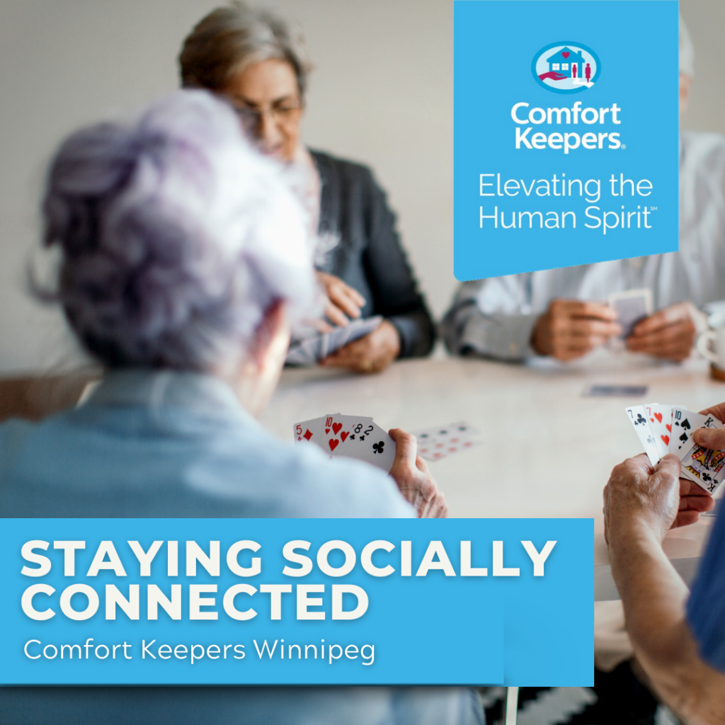 Seniors playing cards at table | Social Connections for Seniors | BLOG POST | Comfort Keepers Winnipeg